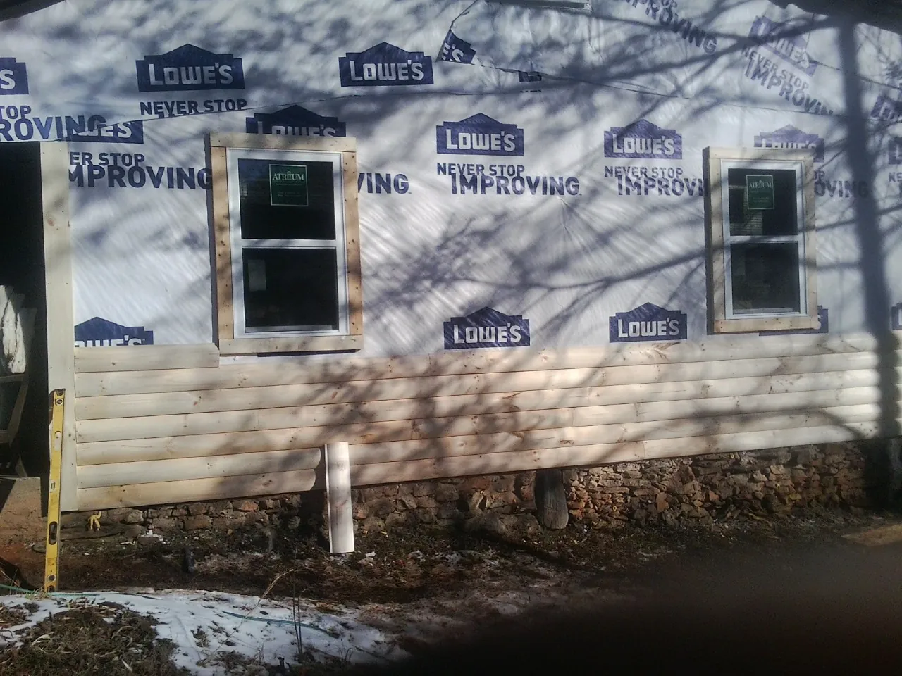 House wrap and new log siding going up on an exterior wall in Port Wentworth