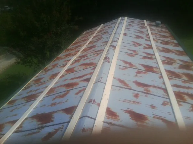 Rusted metal roof panels with new wood purlins before replacement — Storm Damage Roof Repair in Port Wentworth by Roofing Brothers