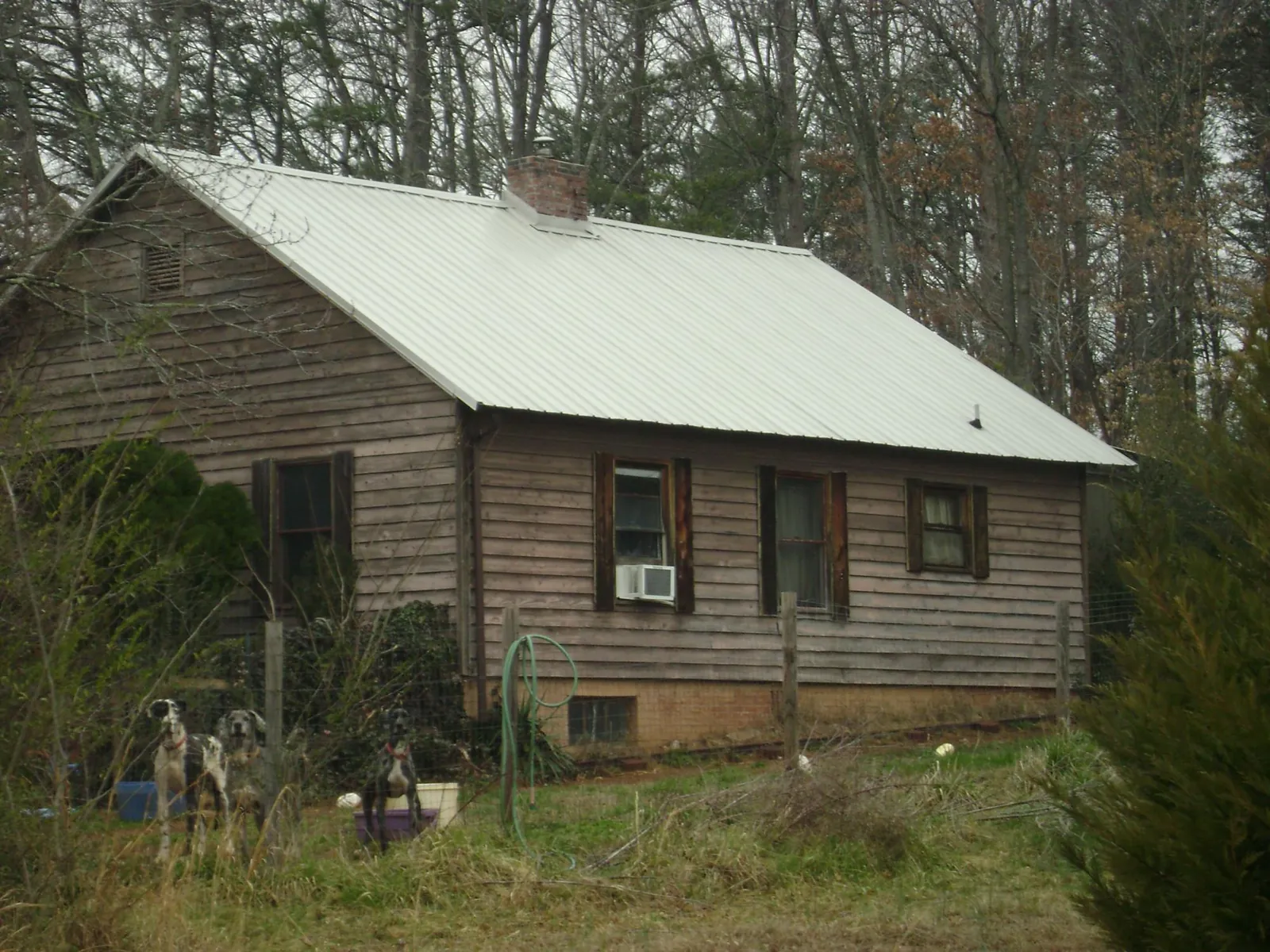 White metal roof on an old wood sided farmhouse, from a Metal Roof Installation job in Port Wentworth